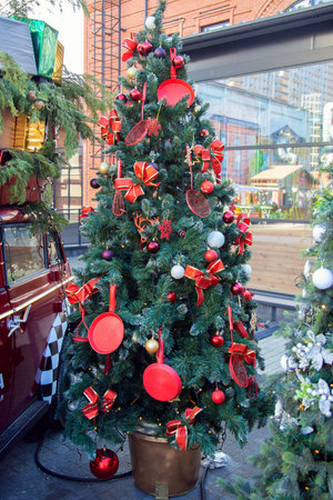 New Year tree on the city street, decorated with kitchen utensils. Christmas decorations from a frying pan and a whisk. Unusual Christmas tree designの写真素材