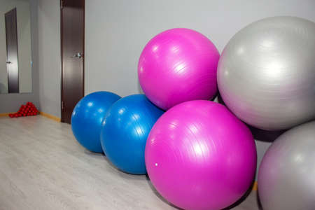 Large fitness balls are in a pile in the corner of the gym. Sports equipment. healthy lifestyleの写真素材