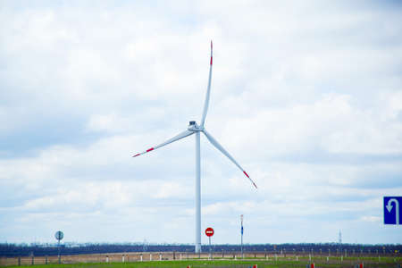 Windmills along the road. Windmills generate electricity. Wind power plant. renewable energy sourcesの写真素材