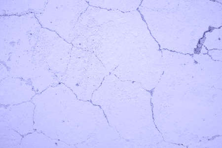 Texture of a white painted wall in cracks. Very Peri Color of the Year 2022の写真素材
