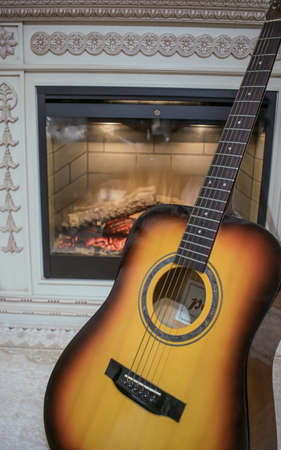 Guitar by the fireplaceの写真素材