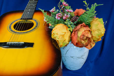 Guitar and flowers on blue backgroundの写真素材