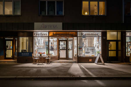 Oslo, Norway - 11/03/2020: Artifix gallery storefront at Sagene with a lot artificial strong lights and shadows on the streetsのeditorial素材