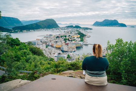 Majestic View of Coastal City Landscape from Hilltop with Lone Traveler Embracing Tranquil Nature