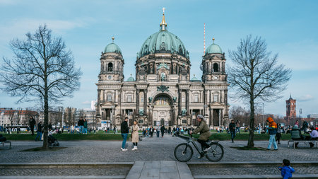 Beautiful Spring Day at Historic Cathedral with Vibrant Public Scene and Blue Sky in Bustling Berlin