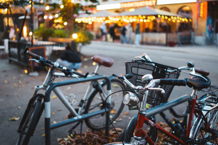 Urban Street Scene with Bicycles and Cozy Cafe Ambiance under Warm String Lights in Autumn Evening