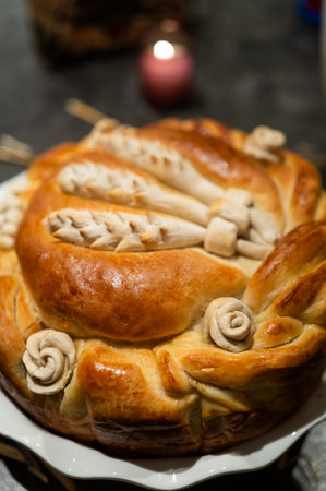 Exquisitely Crafted Artisanal Bread Loaf with Intricate Designs on Elegant Platter in Warm Candlelit...