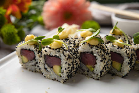 Japanese cuisine. Sushi roll with tuna on white background.
