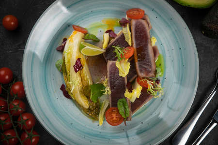 tuna salad and avocado on black background