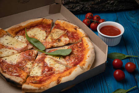Food delivery. Margarita pizza on wooden boardの写真素材