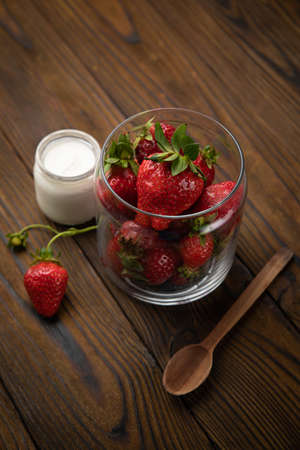 ripe farm strawberries on a wooden backgroundの写真素材