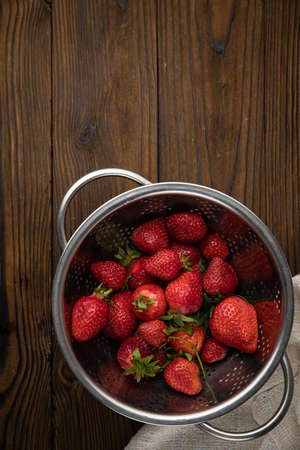ripe farm strawberries on a wooden backgroundの写真素材