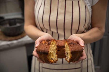 Baked homemade cupcake in the hands of a womanの写真素材