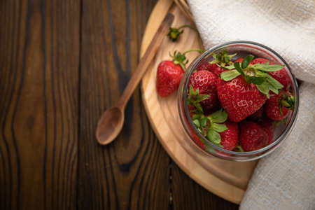 ripe farm strawberries on a wooden backgroundの写真素材