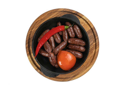 hunting sausages baked in a pan on a wooden board on a white backgroundの写真素材