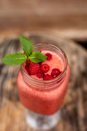 Cool smoothie with raspberries on a wooden backgroundの写真素材