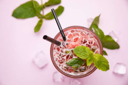 Mojito with strawberries, raspberries and mint. On the pink table.の写真素材
