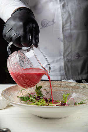 Cold tomato gazpacho soup. On a wooden, white tableの写真素材