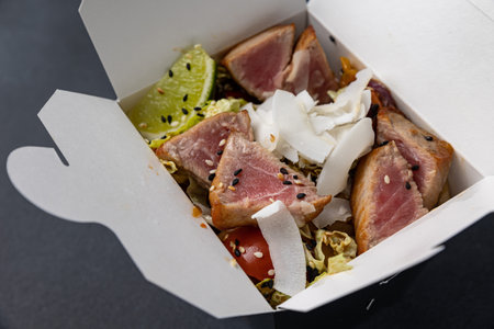 Hawaiian salad with tuna, cheese and vegetables in paper boxの写真素材