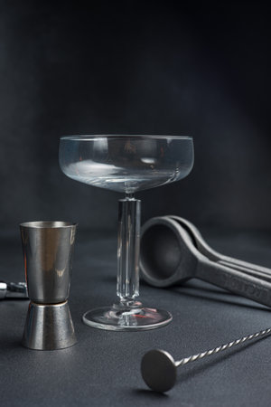 Cocktail shaker and strainer on a black background.の写真素材