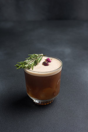 Coffee cocktail with rosemary in a glass on a dark backgroundの写真素材
