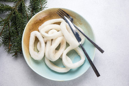 Dried squid rings in a plate on a white background, top viewの写真素材