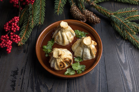 Traditional Georgian dumplings khinkali served in a clay plate on a wooden backgroundの写真素材