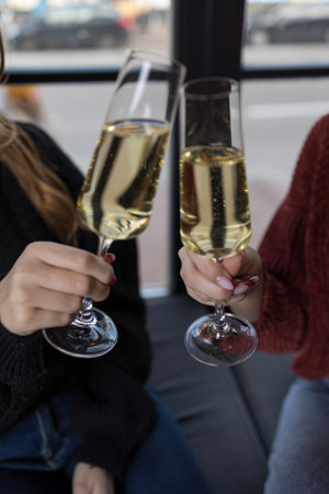 Close-up of two female friends toasting with champagne flutes.の写真素材