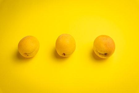 Apricots on a yellow background. Flat lay, top view.の写真素材
