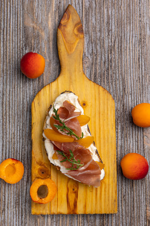 Canape with prosciutto and apricots on wooden backgroundの写真素材