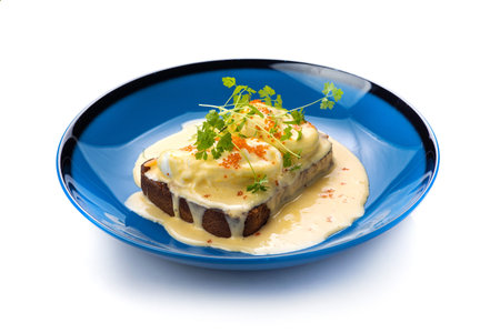 Grilled fish with cream cheese and parsley on a blue plateの写真素材