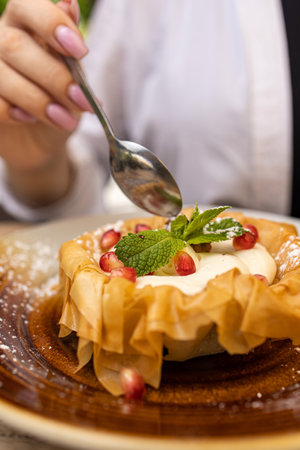 Cake with whipped cream and pomegranate on a plate