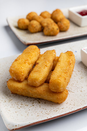 Fried Mozzarella cheese sticks with berry sauce on plate
