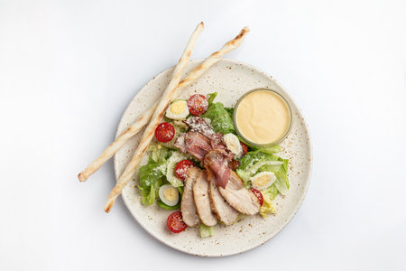 Caesar salad with roasted duck breast, parmesan cheese and cherry tomatoesの写真素材