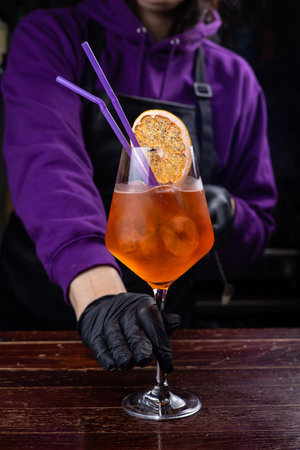 Barman is making a cocktail at the bar counter in a nightclubの写真素材