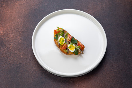 Bruschetta with tomato, mozzarella and basil on a white plateの写真素材