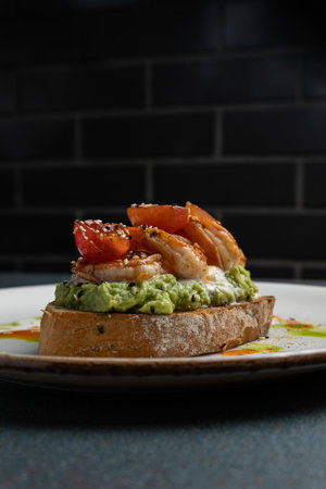 Delicious bruschetta with grilled shrimp, avocado and tomatoesの写真素材