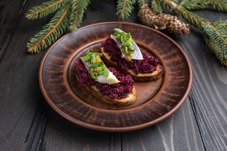 Bruschetta with beetroot, cheese and pesto on wooden backgroundの写真素材