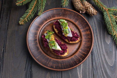 Toasts with beetroot and cream cheese on a wooden background.の写真素材