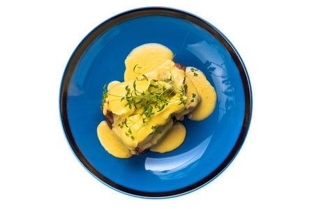 beefsteak with hollandaise sauce on blue plateの写真素材