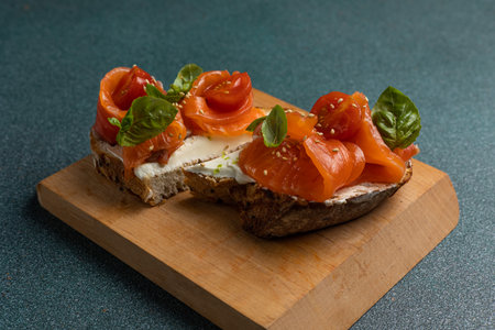 bruschetta with smoked salmon and cream cheese on a wooden boardの写真素材