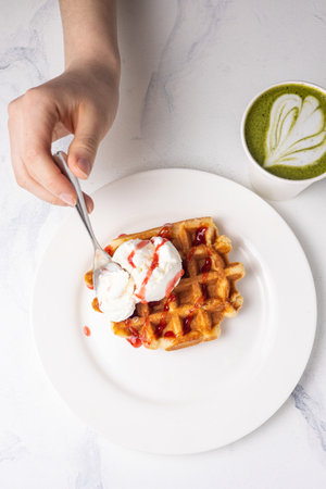 Waffles with ice cream and green tea matcha latte.の写真素材
