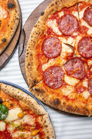 Pizza with salami, mozzarella cheese and tomato sauceの写真素材