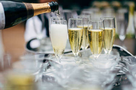 Pouring Champagne to empty champagne glass.の写真素材
