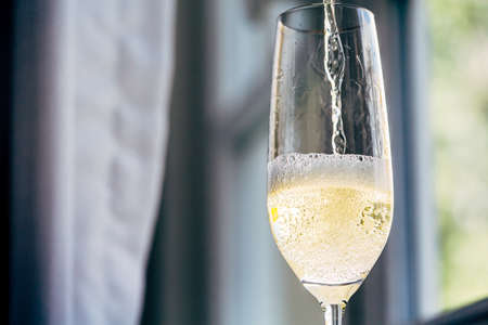 Pouring Champagne to empty champagne glass.の写真素材