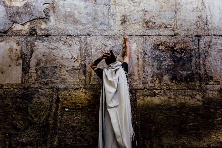 man is praying in the westren wall jerusalem.の写真素材