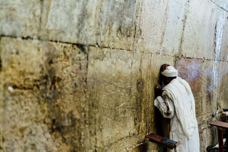 man is praying in the westren wall jerusalem.の写真素材