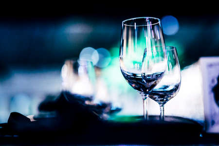 Luxury table settings for fine dining with and glassware, beautiful blurred  background. Preparation for holiday  Christmas and Hannukah dinner night.の写真素材