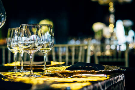 Luxury table settings for fine dining with and glassware, beautiful blurred  background. Preparation for holiday  Christmas and Hannukah dinner night.の写真素材