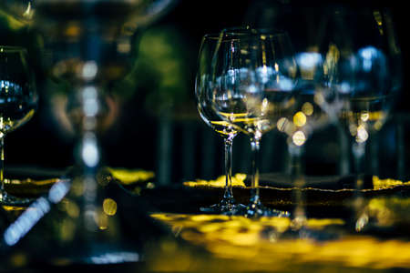 Luxury table settings for fine dining with and glassware, beautiful blurred  background. Preparation for holiday  Christmas and Hannukah dinner night.の写真素材